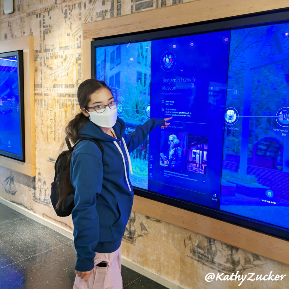 Young girl accessing touch screen at Philadelphia Independence Center