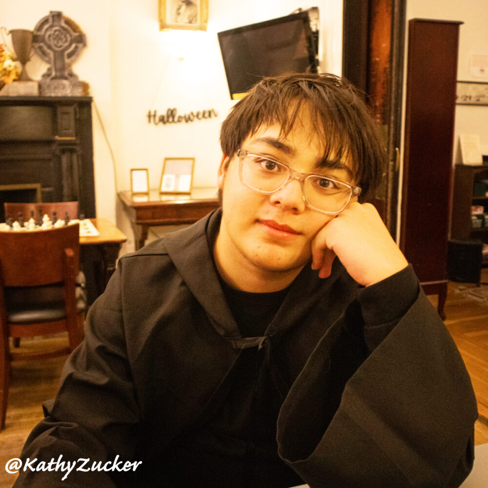 Teenager sitting at table in chess tournament